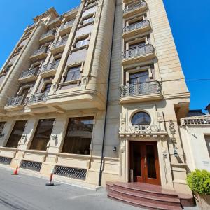 a tall building with balconies on top of it at Capitol Hotel Stay in Baku