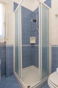 a shower with a glass door in a bathroom at La Baia di Parè in Valmadrera +4 photos