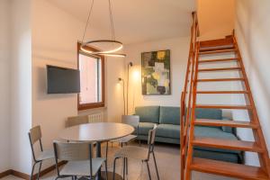 a living room with a table and a couch at ApartmentsGarda - PAI SOL Residence in Pai