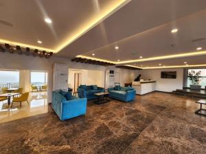 a living room with blue couches and a table at Regenta Waterfront Resort, Dapoli in Dapoli +50 photos