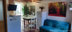 a kitchen with a refrigerator and a table in a room at Bike NIGHT-bike friendly, cozy loft, Finale Ligure in Finale Ligure