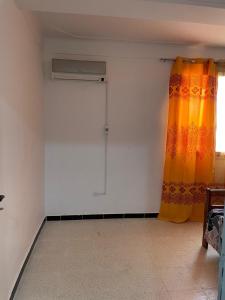 an empty room with a curtain and a window at Appartement Benini in Saïrher