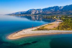 an island in the middle of a large body of water at Apartments Maria & Marta in Seline