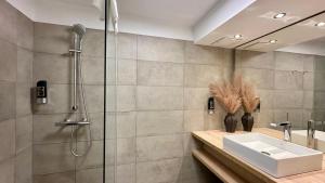 a bathroom with a shower and a sink at Hotel Krone 1512 in Salzburg