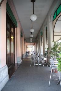 a hallway with tables and chairs on a building at Albergo Ristorante Leon d'Oro in Noventa di Piave