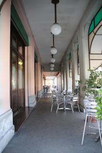 a hallway with tables and chairs on a building at Albergo Ristorante Leon d'Oro in Noventa di Piave