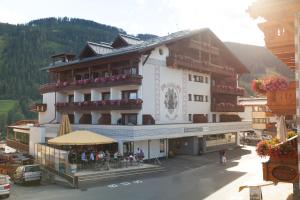 a large building with people sitting outside of it at Familienhotel Post in Serfaus