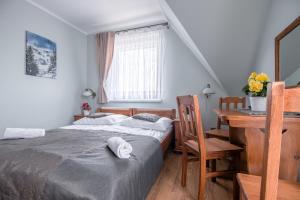 Łóżko lub łóżka w pokoju w obiekcie Tatrzański Gościniec