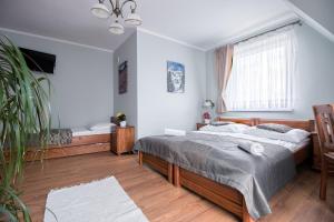 Łóżko lub łóżka w pokoju w obiekcie Tatrzański Gościniec