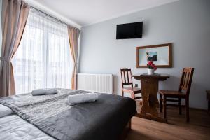 Łóżko lub łóżka w pokoju w obiekcie Tatrzański Gościniec