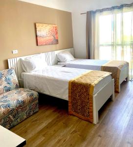 a hotel room with two beds and a couch at Family Residences Brás in São Paulo +17 photos