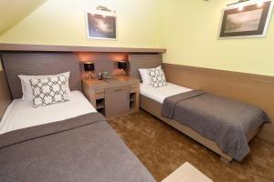 Postel nebo postele na pokoji v ubytování Garni Hotel Leopold I