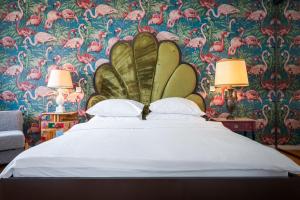 a bedroom with a large bed with a floral wallpaper at Tromostovje apartments in Ljubljana