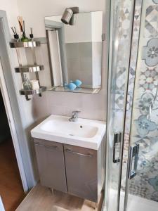 a bathroom with a sink and a shower at Alley 8 in Scilla +24 photos