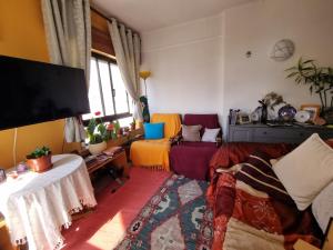 a living room with a couch and a flat screen tv at Sun & Fun in Armacao de Pera in Armação de Pêra