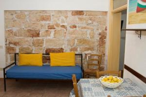 a room with a bed and a table with a bowl of fruit at Terrasini 2000 Casa Vacanze in Terrasini
