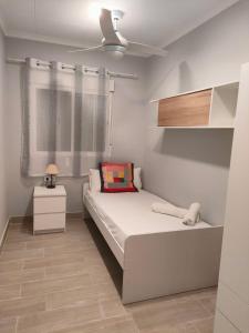 a small bedroom with a bed and a window at Brisas del Lago in Navarrés +8 photos