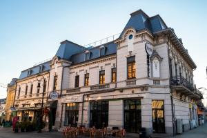 a building with a clock on the front of it at Hotel Splendid 1900 in Craiova