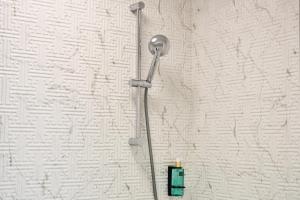 a shower head on a wall in a bathroom at AXO Boutique HOTEL by BUILDING STEFAN in Mamaia Sat/Năvodari