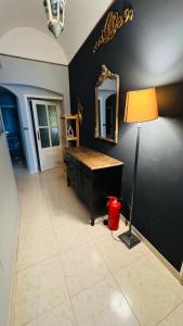 a room with a table and a mirror and a lamp at apt via cernaia rome center in Rome
