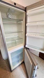 an empty refrigerator with its door open in a kitchen at apt via cernaia rome center in Rome