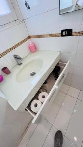 a bathroom with a white sink and some toilets at apt via cernaia rome center in Rome