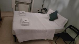 a white bed with towels on top of it at apt via cernaia rome center in Rome