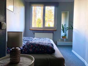 a bedroom with a bed and a window at Labākā vieta uz pasaules in Jūrmala