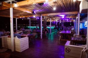 a restaurant with people sitting at tables at night at Zelena Punta Resort in Kukljica +44 photos