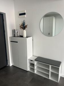 a white cabinet with a mirror in a room at Apartment Cluj, Baciu-Hills in Baciu +14 photos