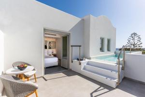a villa with a plunge pool and a bedroom at Meltemi Blu - Adults Only in Perissa