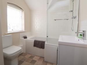 ein weißes Badezimmer mit Toilette und Waschbecken in der Unterkunft Canal Basin Cottage in Nantwich + 20 Fotos