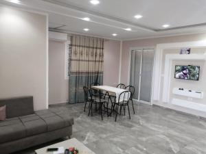 a living room with a couch and a table and chairs at Villa Nesma in Ḩammām al Ghazzāz