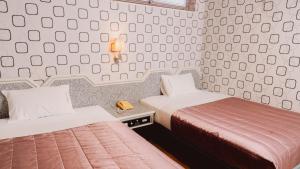 Postel nebo postele na pokoji v ubytování Tong Hsin Hotel