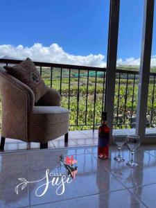 a living room with a chair and two wine glasses at Casa Susi in Tazacorte