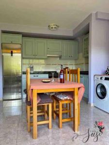 a kitchen with a wooden table with chairs and a microwave at Casa Susi in Tazacorte