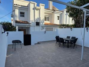 a patio with chairs and a table in front of a house at Bungalow Noa in Calpe