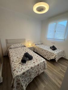 a room with two beds in a room at Bungalow Noa in Calpe +7 photos