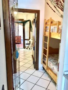 a room with a bunk bed and a doorway at Porto Mannu 25H-Capo d'Orso in Proiettore +1 photo