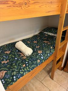 a bed in a bunk bed with a pillow on it at Small cottage on rural equestrian farm suitable for 2 adults and 2 children under 10 maximum in Skegness
