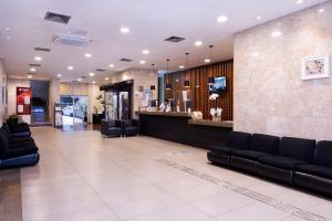 a lobby with couches and a bar in a building at Nikkey Palace Hotel in Sao Paulo
