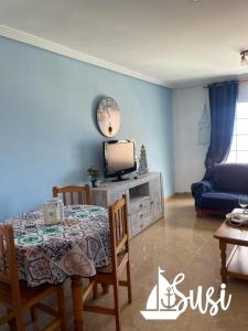 a living room with a table and a tv at Susi in Santa Cruz de la Palma
