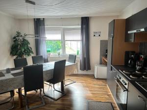 a kitchen with a table and chairs in a room at Ferienhaus nähe Lamspringe mit 5 Schlafzimmer in Winzenburg