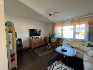 a living room with a couch and a table at Ferienhaus Jastoria in Sassnitz