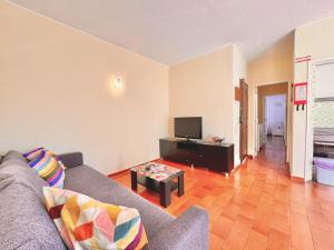 a living room with a couch and a tv at Vilamoura Central 10 by Homing in Vilamoura