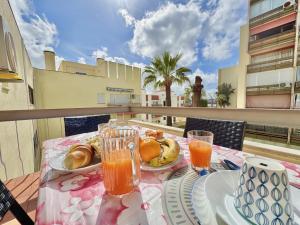 a table with food and drinks on a balcony at Vilamoura Central 10 by Homing in Vilamoura