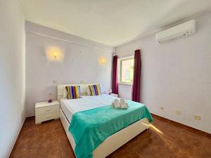 a bedroom with a bed and a window at Vilamoura Central 10 by Homing in Vilamoura