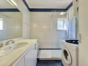 a bathroom with a sink and a washing machine at Vilamoura Central 10 by Homing in Vilamoura +12 photos