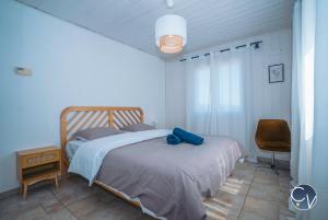 a bedroom with a bed with a blue towel on it at Villa et appartement à Goudargues in Goudargues +57 photos