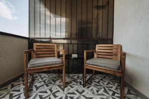 two chairs sitting on a balcony with a window at Cozy Studio No 4 in Sibiu